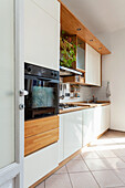 Kitchen with white cabinets and built-in appliances