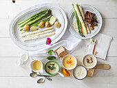 Green and white asparagus with various sauces