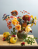 Autumn bouquet with rose hips and quince