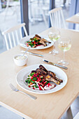 Grilled poussin with fattoush and tahini yogurt