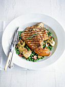 Veal chops with peas, artichokes and bacon