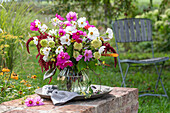 Bouquet of coneflower 'Delicous Nougat' (Echinacea), cosmea (Cosmos), Amaranth (Amaranthus), roses 'Double Delight' (Rosa), broccoli on garden wall