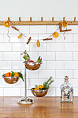 Decoration made from dried orange slices and cinnamon sticks on a wooden hook rail