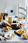 Table set with cheese board with crackers and wine
