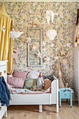 Children's room with floral wallpaper and bed with canopy