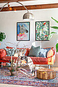 Living room with bright red sofa, artwork and cat