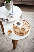 Two-tier white coffee table with coffee set