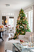 Living room decorated for Christmas with a large Christmas tree and candles