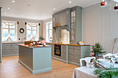 Country-style kitchen with central kitchen island and Christmas decorations