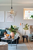 Living room with decorative flower arrangement and pendant light