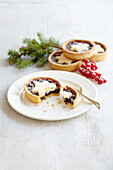 Mince pie with christmas foliage and berries