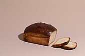 Loaf of sliced Milk bread on Taupe Background