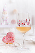 Rose wine in a wine glass with a flower motif