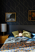 Double bed with bedside cabinet and designer wallpaper