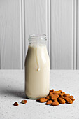 almond milk in a bottle with almonds
