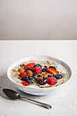Chia pudding with almond milk, berries, seeds, nuts and maple syrup