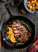 Sliced lamb chop with orange and rosemary