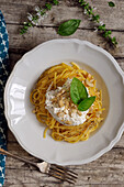 Spaghetti with burrata, nuts and basil