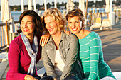 Three good-humoured girlfriends on a ship