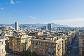 Cityscape And Mountains In The Distance; Genoa, Liguria, Italy