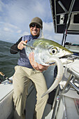 Fisherman Holds A Fresh Caught False Albacore; Cape Cod, Massachusetts, United States Of America