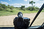 A Camera Propped On The Window Of A Vehicle Pointing Out Into Kruger National Park; South Africa