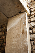 Greek Writing On A Stone Wall At An Amphitheatre; Philippi, Greece