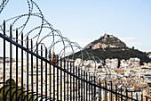 Mount Lycabettus And A Barbed Wire Fence; Athens, Greece