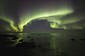 Northern Lights Dancing Over The Langanes Peninsula And The Atlantic Ocean; Iceland