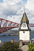 Clock Tower And Red Metal Bridge At The Waterfront; Edinburgh, Scotland