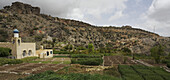 Mountainous Landscape With Village And Terraced Fields Of Roses