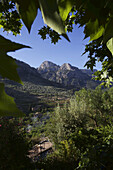 Landschaftsansicht eines Bergdorfs mit Bergen im Hintergrund, Mallorca