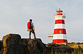 Wanderer mit Blick auf den Brier Island-Leuchtturm, Brier Island, Bay Of Fundy; Neuschottland, Kanada