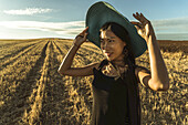 Chinese Young Woman Walking In A Wheat Field; Madrid Spain