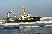 A Rusty Sunken Abandoned Ship In The Waves Of Atlantic Ocean On The Namibian Coast  (Zeila Shipwreck); Namibia