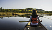 Woman Canoeing In Algonquin Park; Ontario, Canada