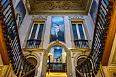 Interior of a building with artwork and decorative stair railings; Lisbon, Lisboa Region, Portugal