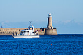 Pier with lighthouse and boat on the River Tyne; South Shields, Tyne and Wear, England