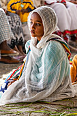 A young Ethiopian girl at the Church of Saint George during Timkat, the Orthodox Tewahedo celebration of Epiphany, celebrated on January 19th; Ziway, Oromia Region, Ethiopia