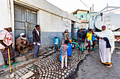 People by a water truck in Harar Jugol, the Fortified Historic Town; Harar, Harari Region, Ethiopia