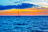 Sailboat in the ocean off the coast of Kamaole One and Two beaches, Kamaole Beach Park; Kihei, Maui, Hawaii, United States of America