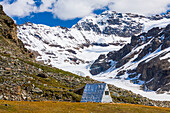 Thayer Hut, located in a remote area of the eastern Alaska Range beside Castner Glacier, has provided shelter for mountaineers and others since it was built in the 1960s; Alaska, United States of America
