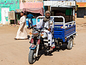Sudanese man driving a motorized tricycle; Abri, Northern State, Sudan