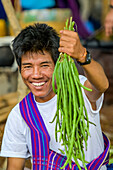 Man holding fresh beans; Shan State, Myanmar