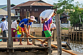 Boys working at the waterfront; Yawngshwe, Shan State, Myanmar