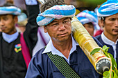 Group of men with a rocket walking together during a festival; Yawngshwe, Shan State, Myanmar