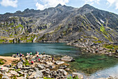 Hikers and swimmers at Gold Cord Lake in summertime in the Independence Mines area of Hatcher Pass near Palmer, South-central Alaska; Alaska, United States of America