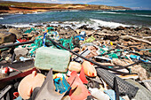 Much of the North side of the island of Molokai in inaccessible. Trade winds blow onshore regularly bringing with them piles of plastic that has been floating around the Pacific Ocean for years and years; Molokai, Hawaii, United States of America