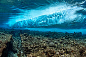 Surf crashes on the reef off the island of Yap in Micronesia. Underwater view of a wave breaking; Yap, Federated States of Micronesia