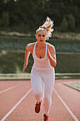 Woman running on a track; Wellington, New Zealand